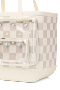 A cream and beige checkered tote bag with a clear plastic front pouch pocket and cream handles, shown on a white background.