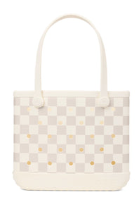 A structured tote bag featuring a cream and light beige checkerboard pattern with small gold polka dots, set against a plain white background.