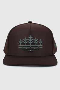 A dark brown snapback cap featuring a green embroidered graphic of pine trees and water on the front panel, set against a light gray background.