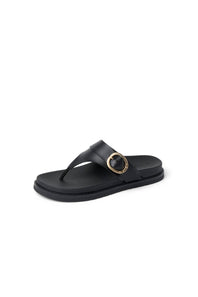 Black sandal with a gold buckle on a white background