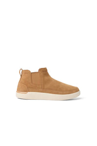 A tan suede ankle boot sneaker with elastic side panels and a thick off-white sole, shown from a side profile on a white background.