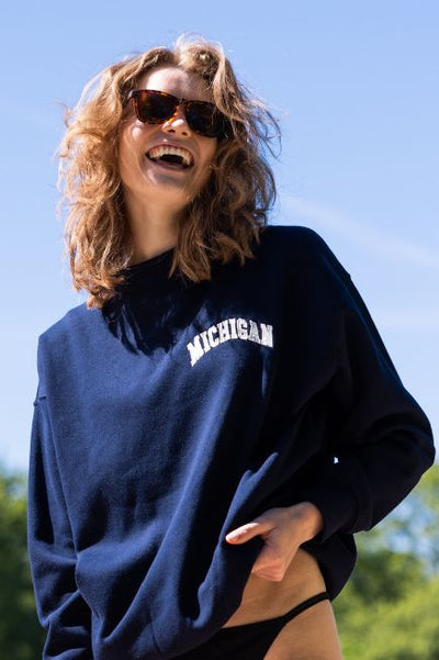 Girl wearing a navy sweatshirt with 