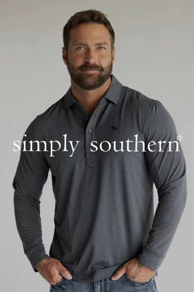 A man wearing a dark grey long sleeve polo standing in front of a plain studio background and dark overlay with text Simply Southern