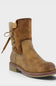 A tan suede ankle boot with a pull tab, side laces, and a chunky sole with a purple accent line, shown against a light gray background.