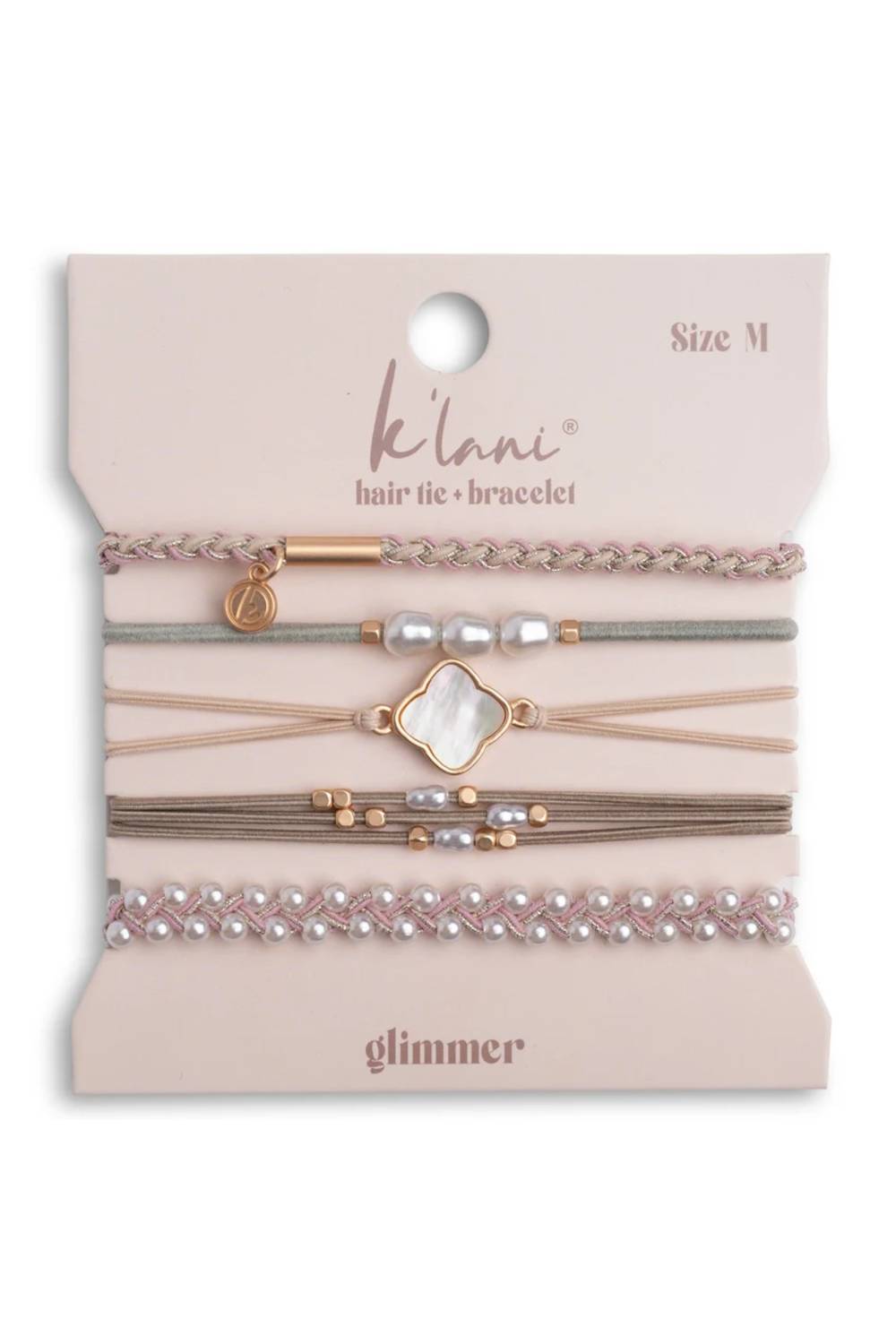A set of five K'lani hair tie and bracelet elastic bands with pearls, beads, and a clover charm, displayed on a pink card labeled 'Size M' and 'glitter'.
