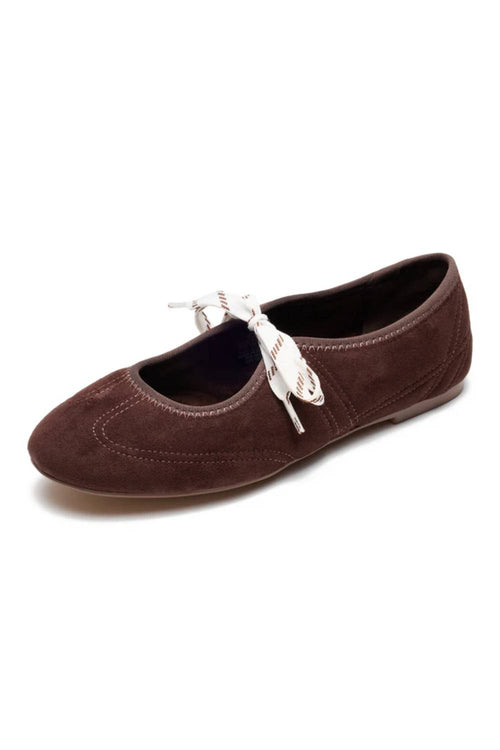 A dark brown suede ballet flat shoe with a white bow detail across the vamp, shown on a plain white background.