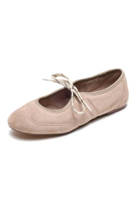 A single women's ballet flat shoe in a light beige suede-like material, featuring a matching beige rope-style bow on the front, set against a plain white background.