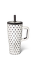 A white ceramic travel tumbler with black polka dots, a white handle, a black lid, and a black straw, shown on a white background.