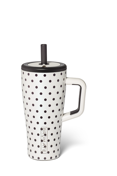 A white ceramic travel tumbler with black polka dots, a white handle, a black lid, and a black straw, shown on a white background.