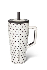 A white ceramic travel mug with black polka dots, a white handle, and a black lid with a black straw, shown on a white background.