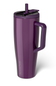 A tall, insulated travel tumbler in a deep purple color, featuring a matching purple handle and lid with a straw, on a clean white background.