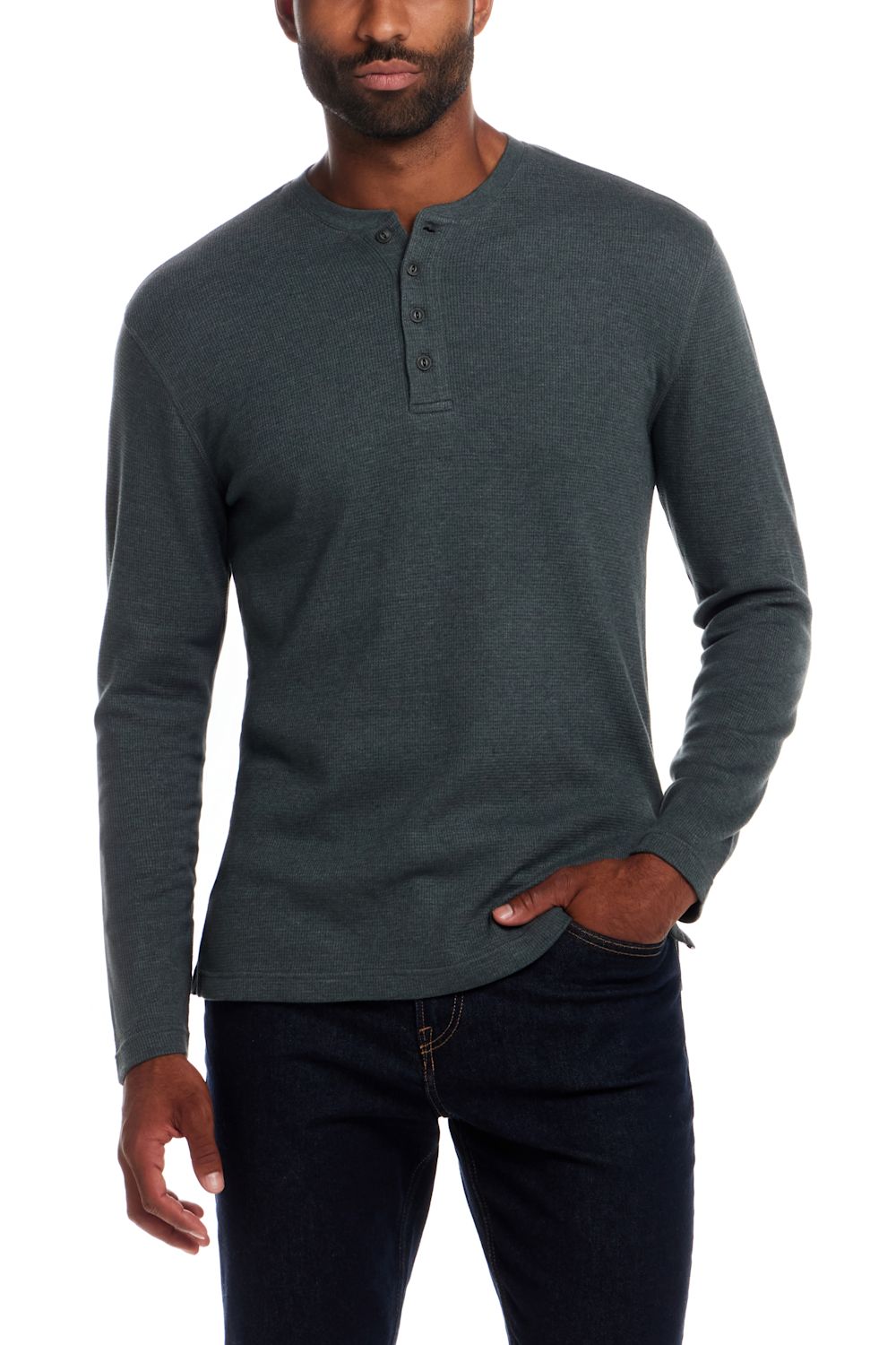 A man wearing a dark gray long-sleeve henley shirt and dark blue jeans, standing against a plain white background.