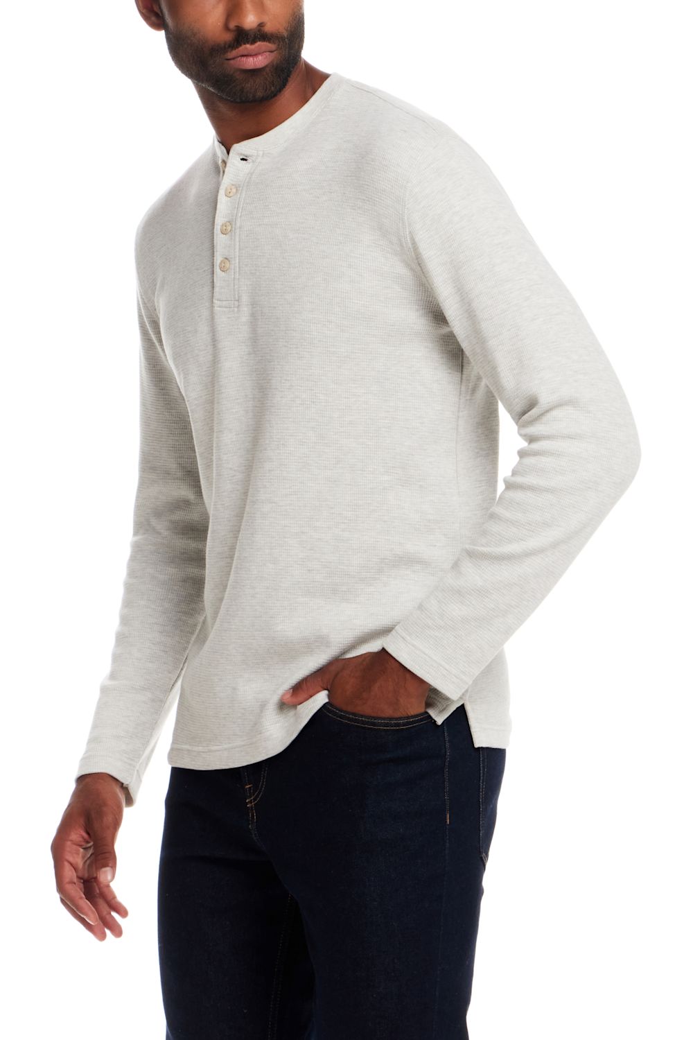 A man wearing a light heather gray long-sleeve henley shirt with dark navy jeans, shown from the waist up against a plain white background.