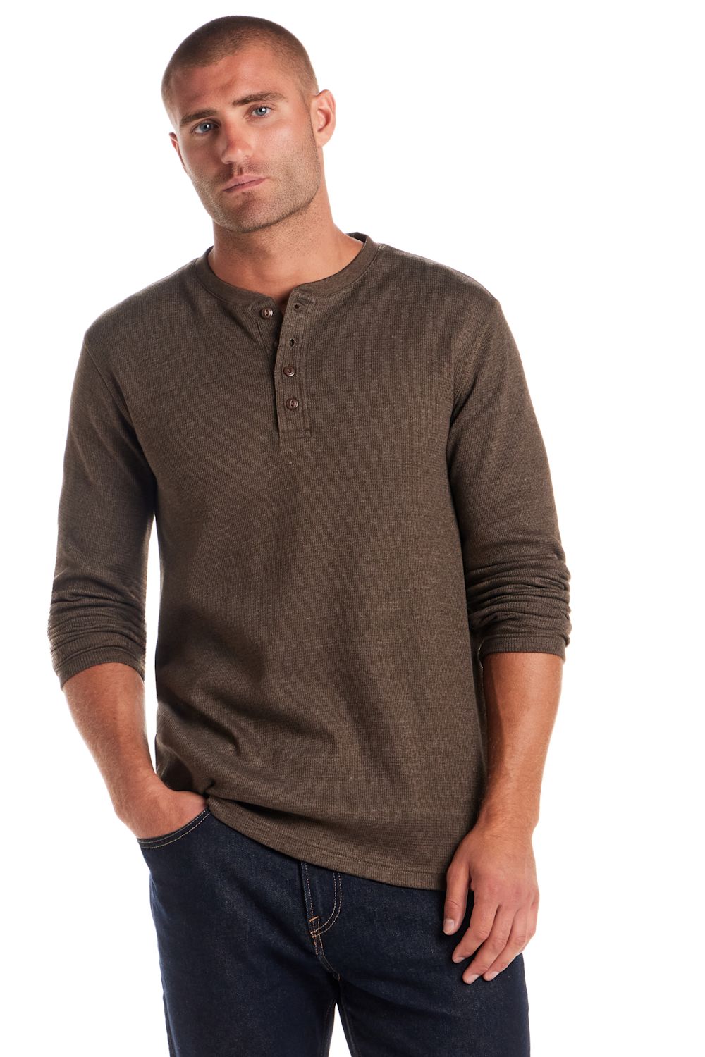 A man wearing a brown long-sleeve henley shirt and dark blue jeans, standing against a plain white background.
