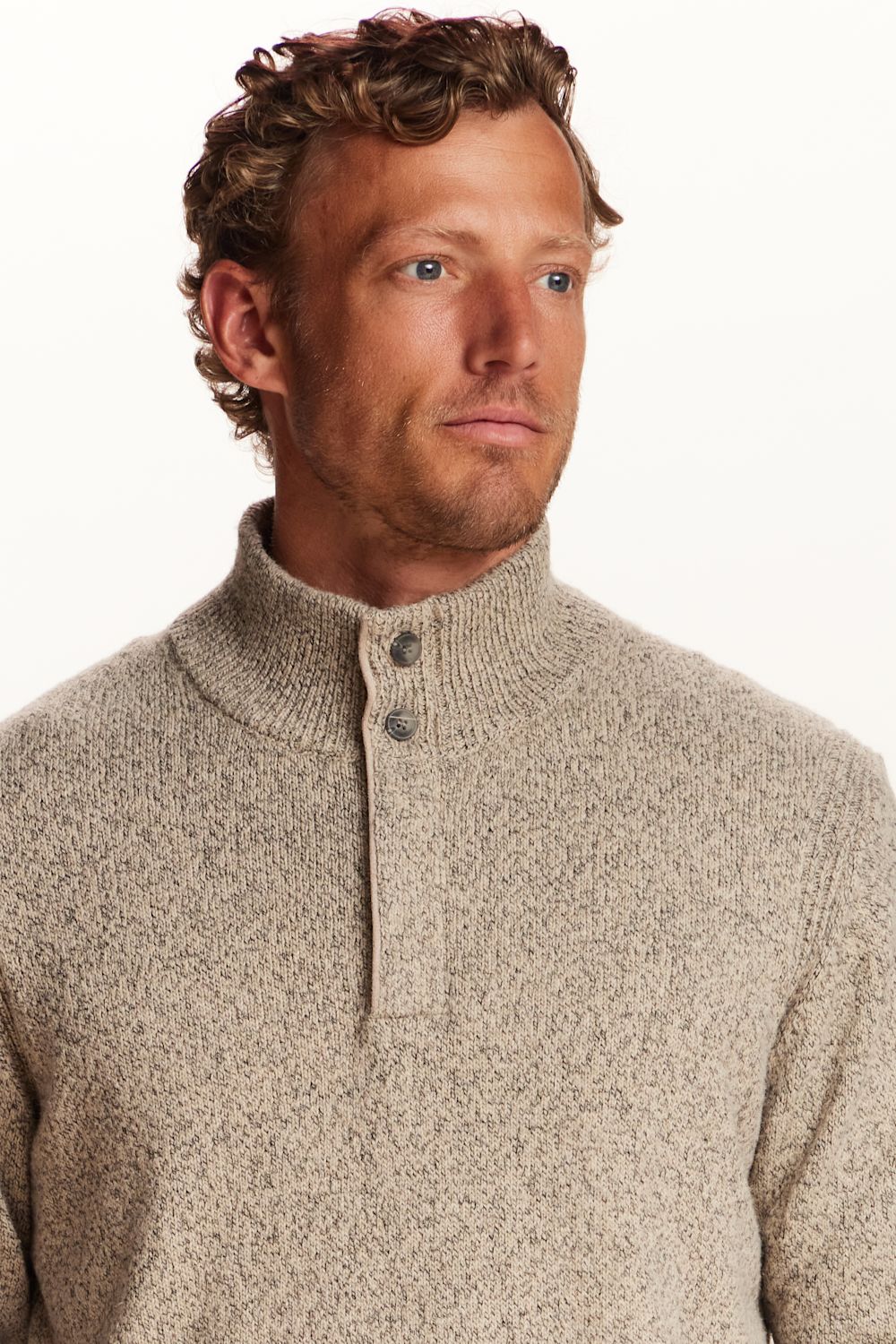 A man wearing a textured, heathered oatmeal-beige knit sweater with a mock neck and a three-button placket, photographed against a clean white background.