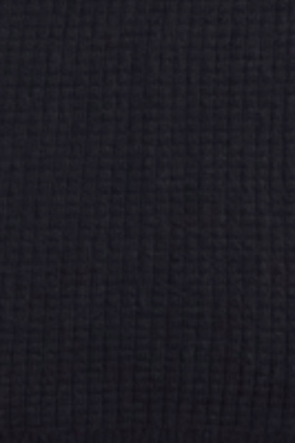 A close-up texture shot of a dark navy blue waffle-knit fabric.