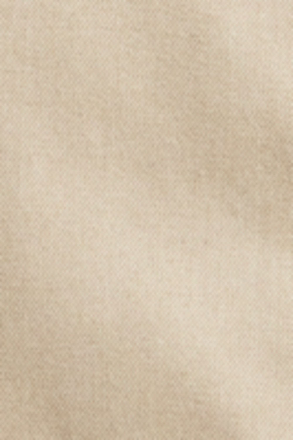 A close-up texture shot of a soft, warm beige fabric with a fine, slightly mottled weave.