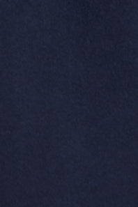 A close-up of a dark navy blue textured fabric surface.