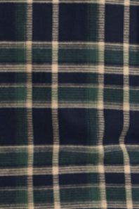 A close-up of a plaid fabric pattern with dark navy blue, forest green, and off-white stripes.