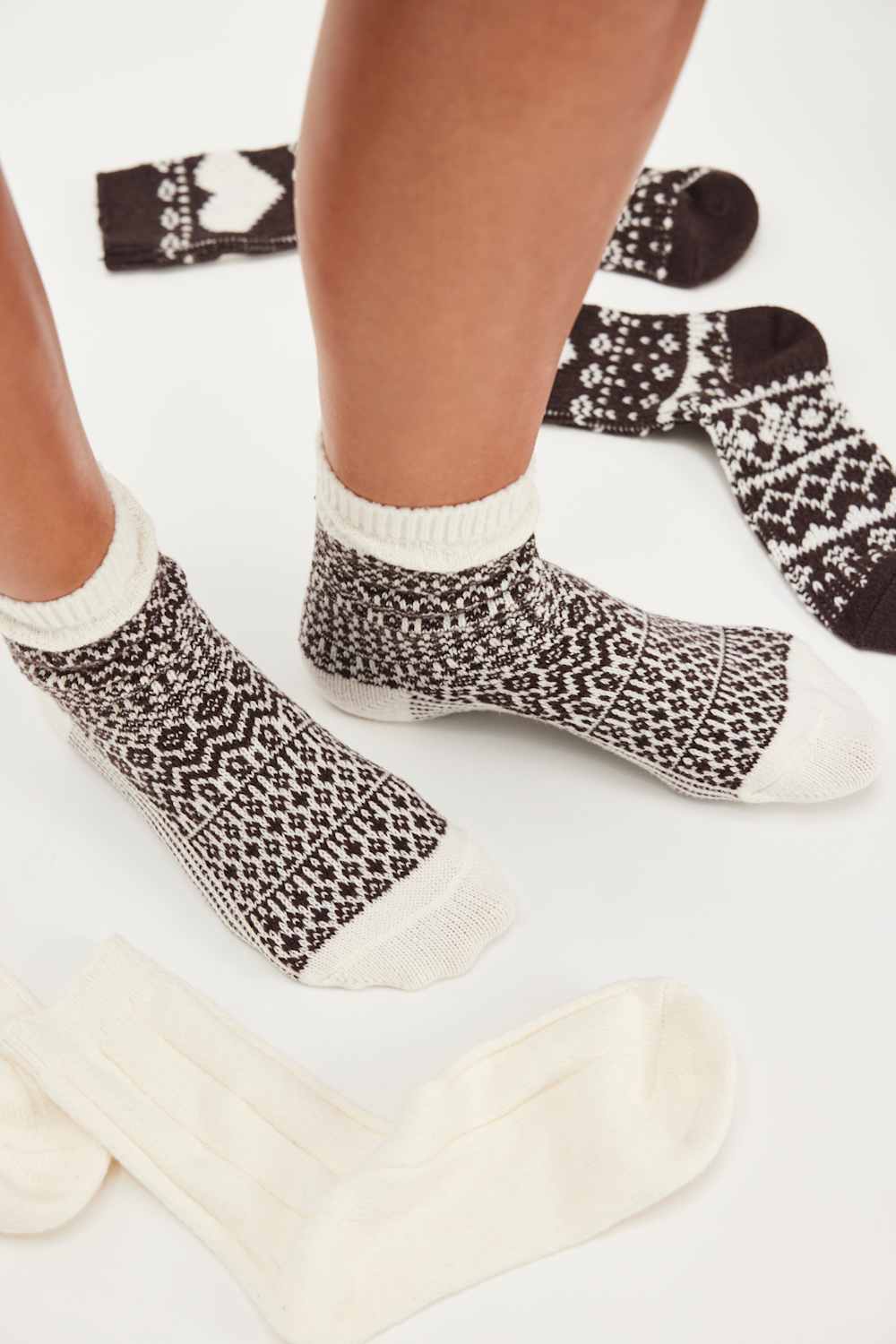 Person wearing patterned socks on a light background