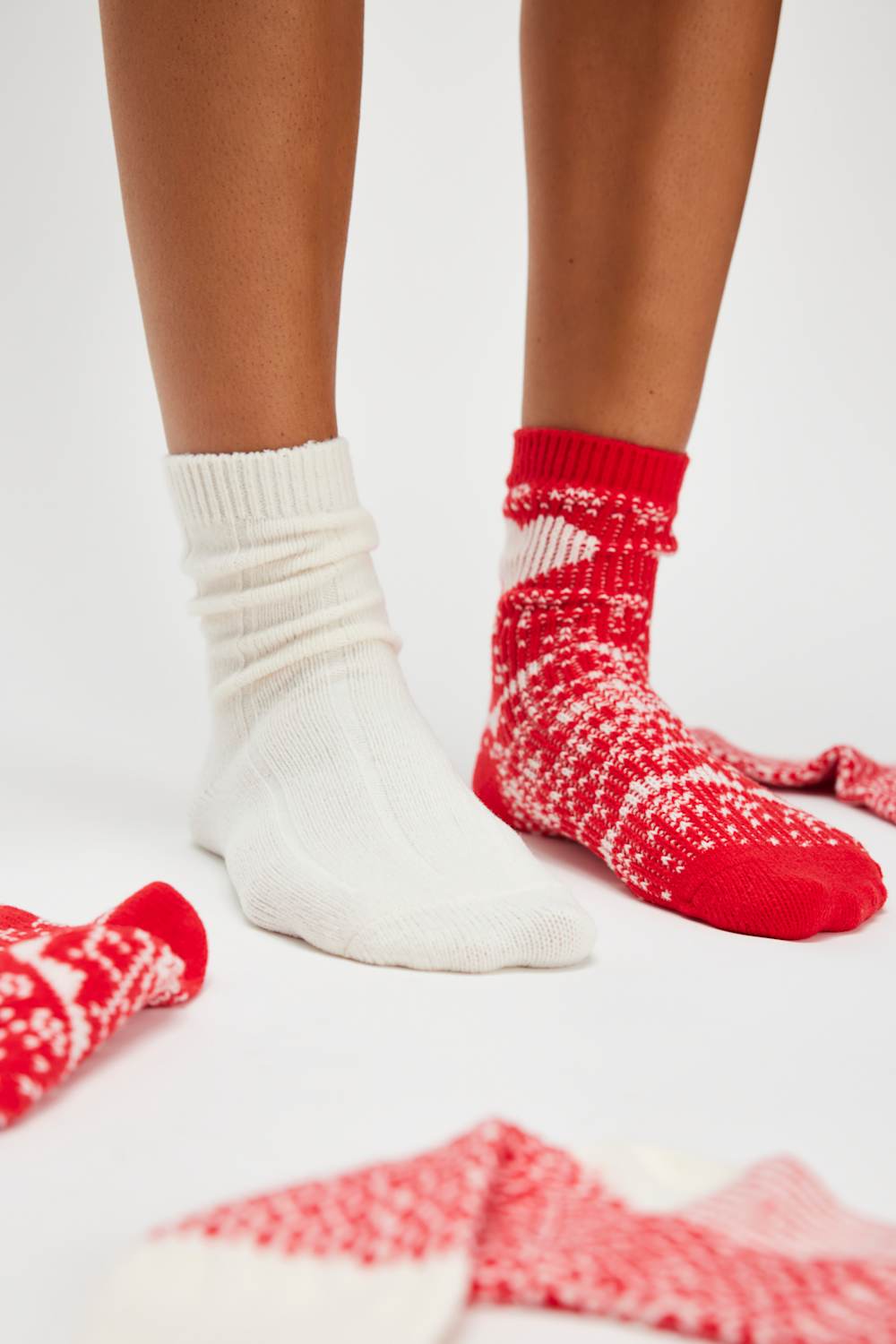 White and red patterned socks on a white background