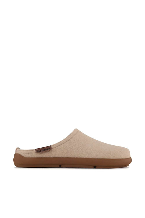 A single slip-on clog-style shoe in light beige fabric with a brown sole, shown in side profile against a plain white background.