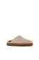 A single slip-on clog-style mule shoe in light beige suede or fabric with a brown sole, shown from the side against a plain white background.