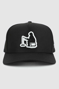 A black baseball cap featuring a white embroidered graphic of a person fishing on a line, shown against a light gray background.