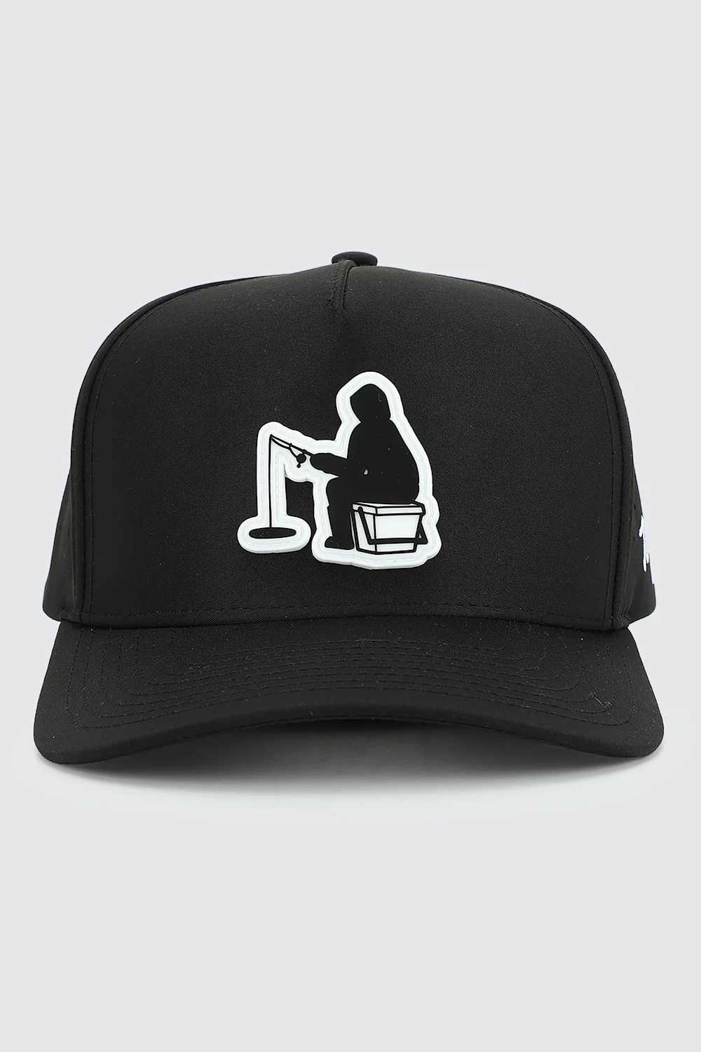 A black baseball cap featuring a white embroidered graphic of a person fishing on a line, shown against a light gray background.
