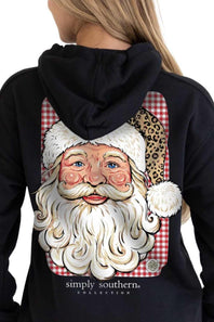 A woman wearing a black hoodie from the back, featuring a large graphic print of Santa Claus with a white beard, red and white gingham background, and a leopard print accent on the hat. The brand name 'simply southern collection' is printed below the graphic.