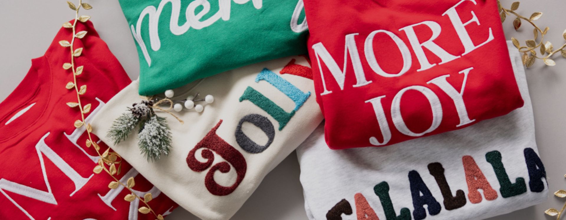 Holiday fleece sweatshirts with festive decorations.