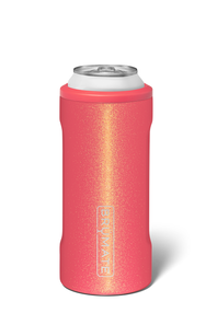 Sparkly insulated slim can cooler in a coral pink color, with Brumate logo on front 
