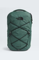 Green backpack with The North Face logo on a light gray background