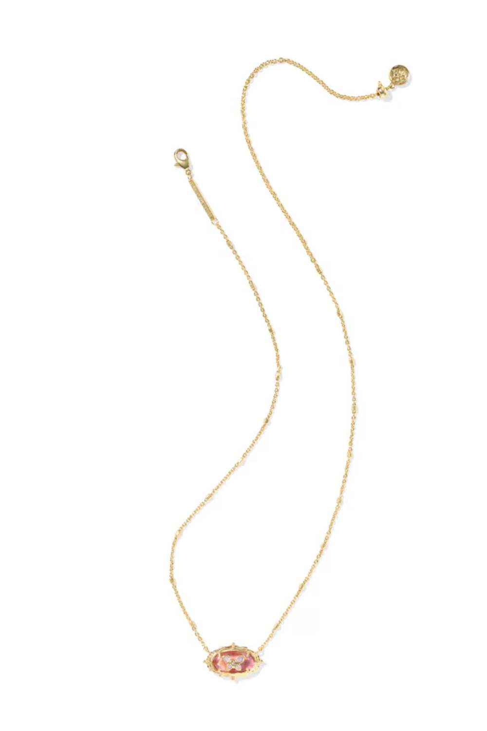 A delicate gold chain necklace featuring an oval pendant with a pink and gold pattern, displayed on a clean white background.