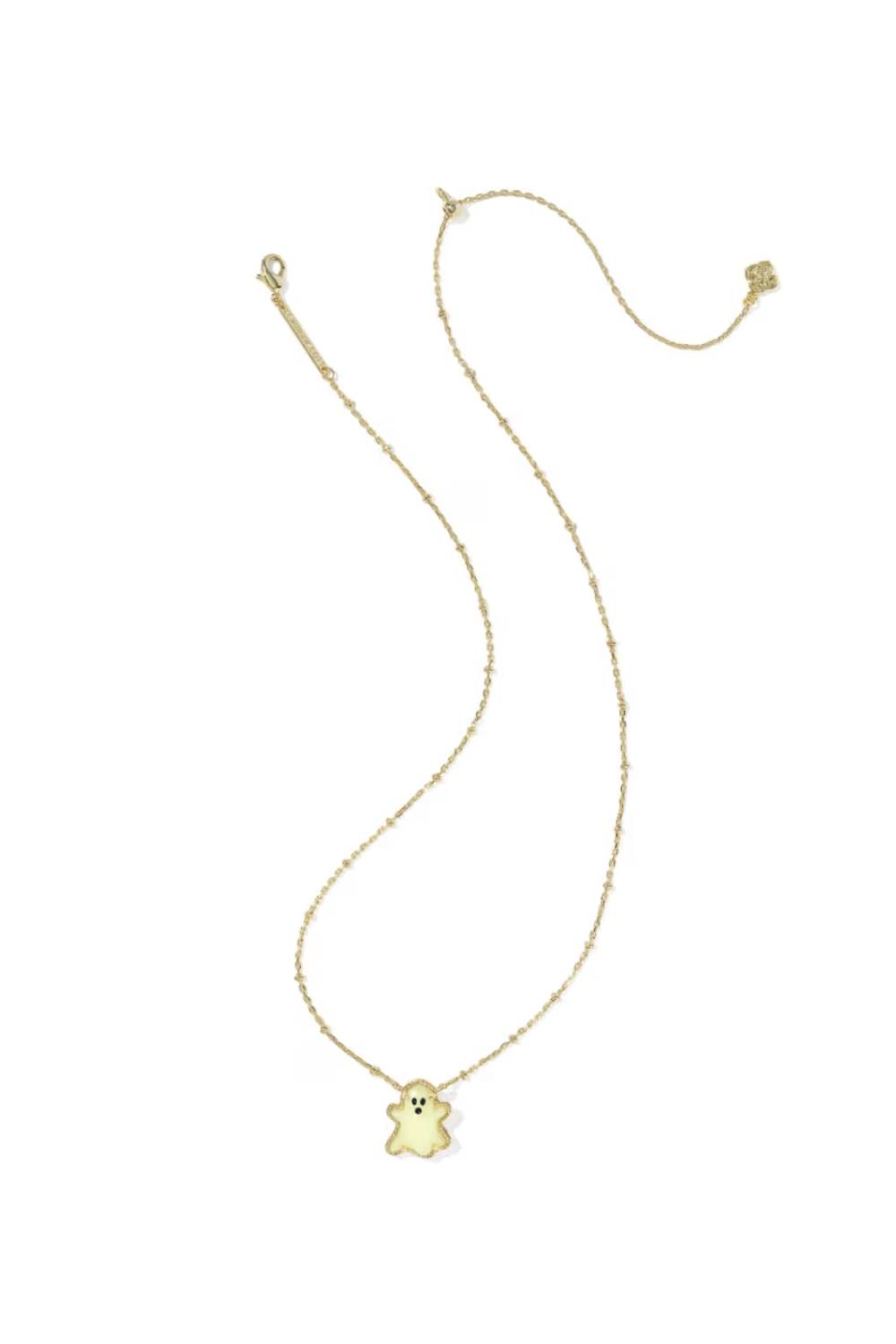 A delicate gold chain necklace featuring a small, cute ghost-shaped pendant with a yellow face, displayed on a clean white background.