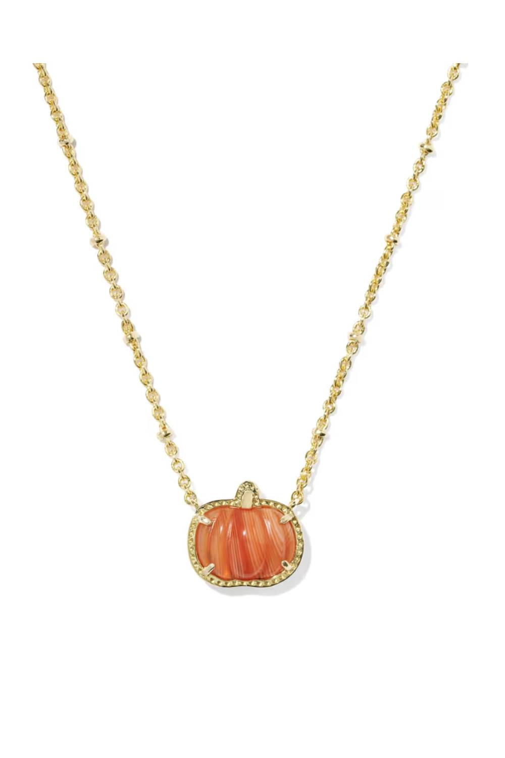 A gold chain necklace featuring a pumpkin-shaped pendant with a carved orange stone and a delicate diamond border, set against a plain white background.