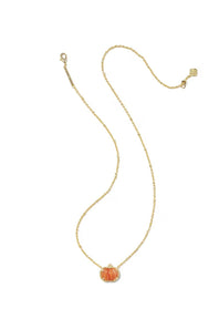 A delicate gold chain necklace featuring a small, vertically ribbed orange pumpkin pendant with a clear crystal halo, displayed on a clean white background.