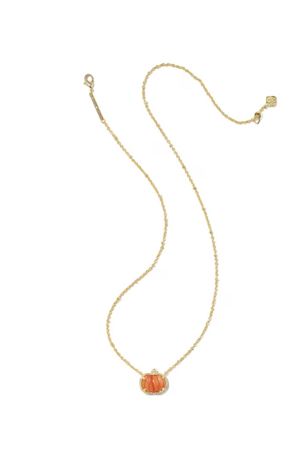 A delicate gold chain necklace featuring a small, vertically ribbed orange pumpkin pendant with a clear crystal halo, displayed on a clean white background.