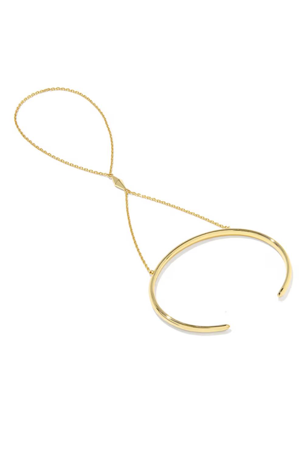 A gold-toned minimalist necklace featuring a thick open circular cuff connected to a delicate chain loop, shown on a plain white background.