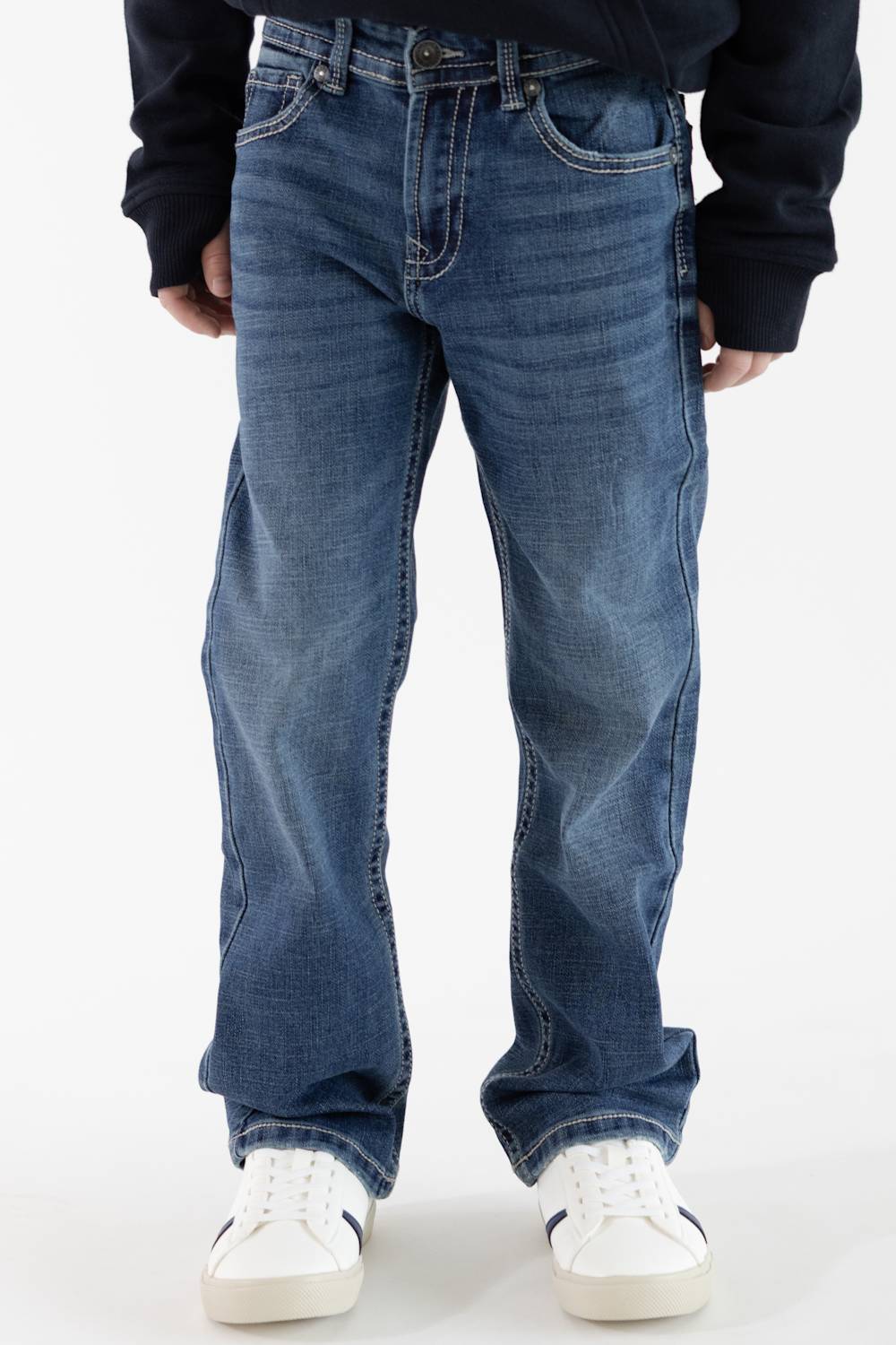 Front-facing view of a boy wearing Axel Jeans medium-wash straight-leg denim featuring light whiskering on the thighs, styled with white sneakers.