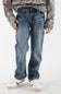 Boy wearing dark wash denim jeans with a long sleeve camo hoodie and white sneakers standing in front of a white studio background