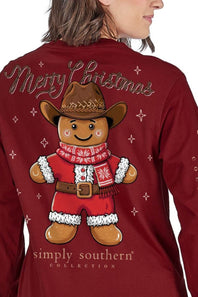 A woman wearing a dark red long-sleeve shirt, viewed from the back. The shirt features a large graphic of a gingerbread man wearing a cowboy hat and red sweater, with 'Merry Christmas' written above and 'simply southern COLLECTION' below.