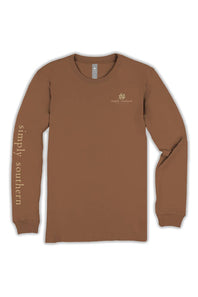 A brown long-sleeve t-shirt with 'simply southern' printed vertically in gold on the left sleeve and a small gold logo on the left chest, displayed on a clean white background.