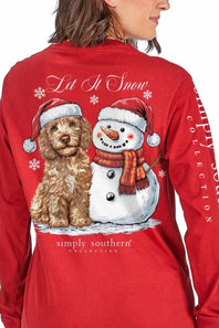 A woman wearing a red long-sleeve shirt, shown from the back. The shirt features a large graphic print of a golden dog and a snowman wearing Santa hats, with the text 'Lit It Snow' and 'simply southern collection' printed on the back.