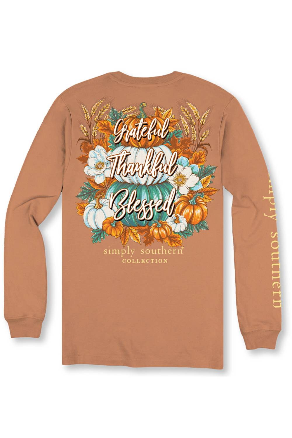 A long-sleeve t-shirt in a warm terracotta or rust color, shown from the back. The back features a large, detailed autumn graphic with pumpkins, white flowers, wheat, and the words 'Grateful Thankful Blessed' in script.