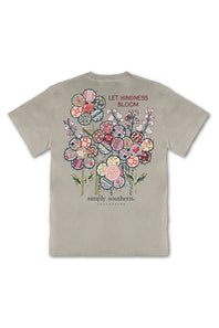 A light beige crewneck t-shirt with a colorful floral graphic on the back, featuring the text 'LET KINDNESS BLOOM' and 'simply southern.' COLLECTIONS.