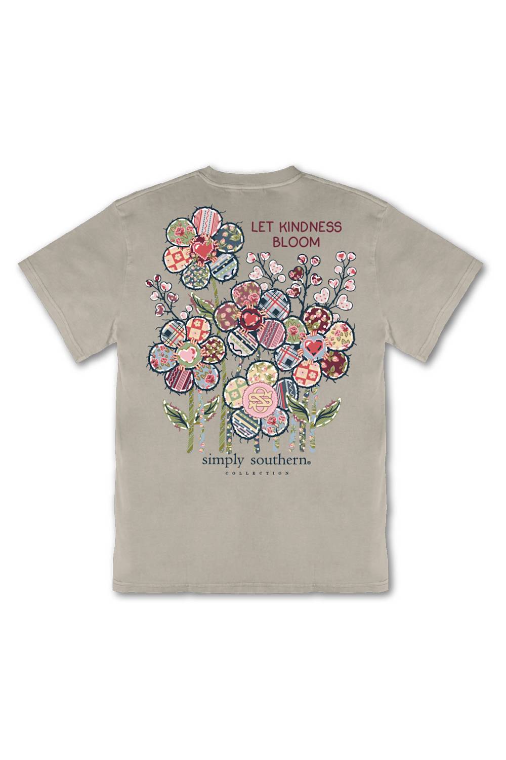 A light beige crewneck t-shirt with a colorful floral graphic on the back, featuring the text 'LET KINDNESS BLOOM' and 'simply southern.' COLLECTIONS.
