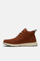 A pair of brown suede Timberland sneakers with white soles, displayed against a light gray background.