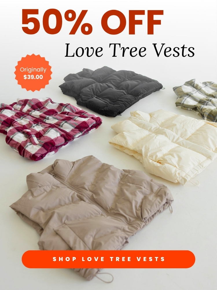Promotional banner displaying large red text reading 50% OFF above Love Tree Vests in a serif font. An orange starburst badge on the left indicates Originally $39.00. Below the text is an array of folded vests in various colors and plaid patterns laid out on a light surface, with an orange rectangular button at the bottom reading SHOP LOVE TREE VESTS