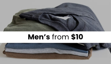 A stack of basic t-shirts. The image has a dark overlay and a white stripe with text that reads Men's from $10